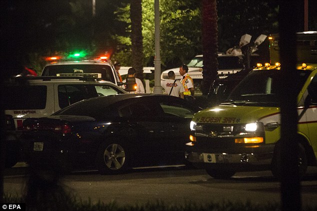 The boy was dragged into the Seven Seas Lagoon near the Grand Floridian Resort & Spa around 9.20pm on Tuesday. Above, police officers and emergency teams at the scene