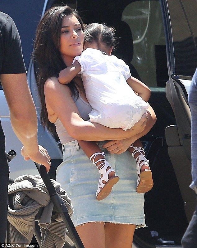 Mom's the word! The 35-year-old carried her sleepy daughter North